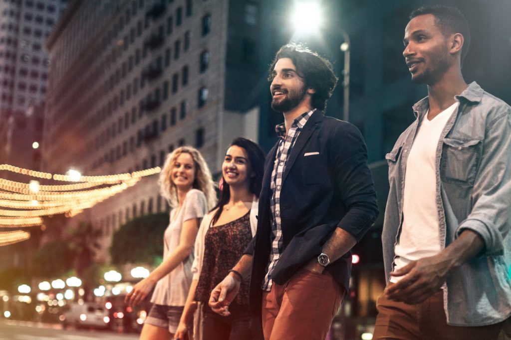 Friends walking downtown to Birmingham events at night